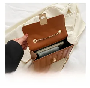 Internal view of brown quilted crossbody bag showing space for phone and wallet