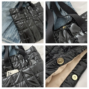 Detail view of black quilted puffer bag showing magnetic closure and side pocket