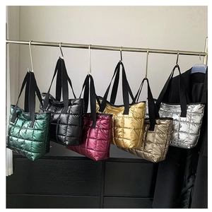 Set of six metallic quilted puffer tote bags in diverse colors hung on a rack