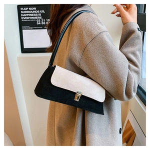 Retro two-tone underarm bag with black leather and beige suede flap featuring gold lock