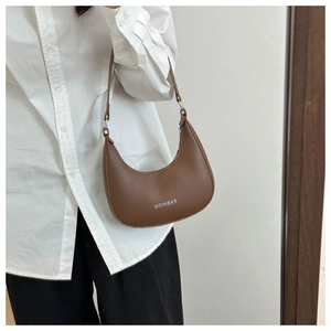 Close-up of a brown crescent shoulder bag with fashion lettering and adjustable strap
