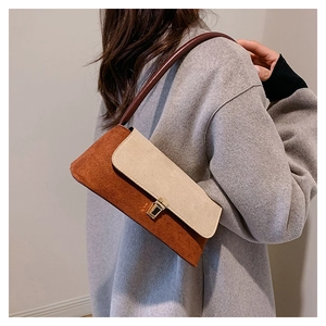 Detail showing the vintage-style contrast paneling and matte texture of the underarm bag