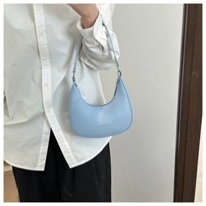 Detail view of light blue hobo bag with printed fashion logo and slim shoulder strap