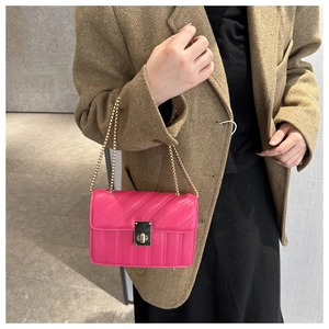 Fuchsia quilted chain shoulder bag with gold twist-lock and geometric texture design