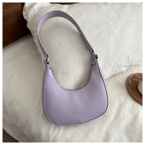 Detail of lavender crescent bag with FASHION embossment on textured leather finish