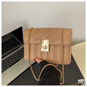Detail of khaki quilted chain bag featuring a gold rectangular twist lock and PU texture