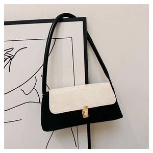 Detail of minimalist contrast shoulder bag with matte texture and golden buckle lock