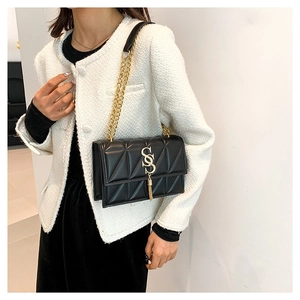 Quilted nylon tote bag with gold chain strap and SS logo shown on female model