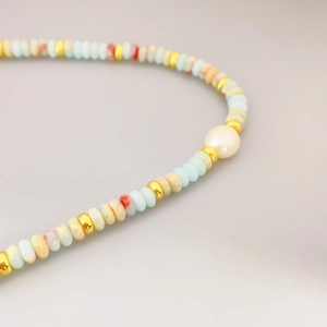 Handmade necklace featuring colorful macaron beads, golden spacers and a white freshwater pearl