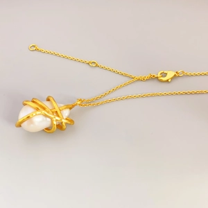Vintage Baroque pearl pendant necklace with gold plated chain on light grey background