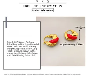 Detail view of 18K gold plated double spiral earrings with red enamel coating