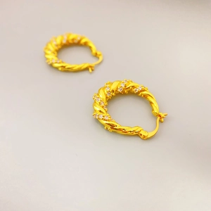 Elegant gold-plated twisted hoop earrings with sparkling cubic zirconia stones for women