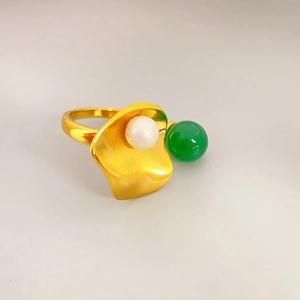 Elegant gold ring featuring white pearl and green chalcedony in a lotus leaf design