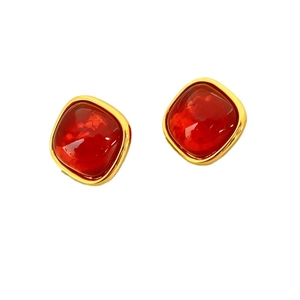 Vintage gold plated square earrings with deep red resin stone on white background