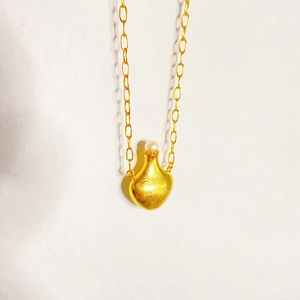 Golden perfume bottle pendant necklace with cultured pearl on a classic cable chain