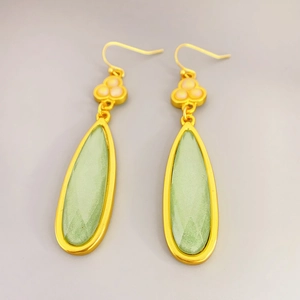 Vintage gold-plated teardrop earrings with green faceted stone and floral charms