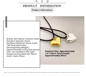 Detail of 18K gold plated brass heart pendant on black braided long necklace rope