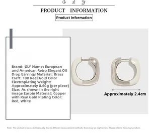 Detail view of cream enamel huggie earrings with 18K gold plating and 2.4cm width size guide