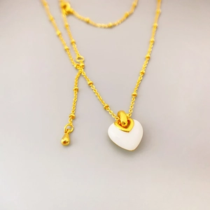 Elegant gold bead chain necklace featuring a minimalist white enamel heart-shaped pendant