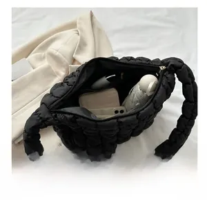 Large black quilted bubble shoulder bag showing spacious interior with daily essentials