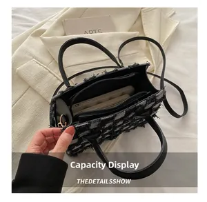 Internal view of plaid tote bag showing dual zipper compartments and large capacity