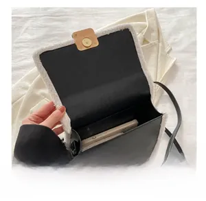 Detail view of the black leather crossbody bag interior showing smartphone storage capacity