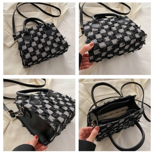 Detail view of plaid denim handbag with fringe trim and multi-layer internal compartments