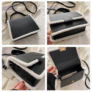 Detail view of contrast black leather and white sherpa trim bag with adjustable strap