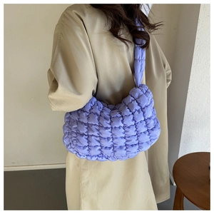 Detailed close-up of quilted bubble texture on a light purple nylon cloud bag