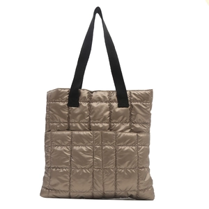 Champagne quilted tote bag with black strap handles and front pocket for winter