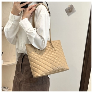 Close-up of khaki quilted tote bag with rhombus stitching on soft synthetic leather