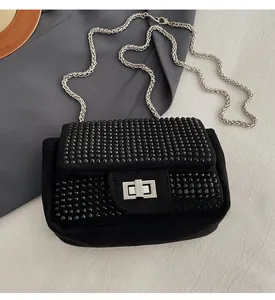 Detailed close-up of a black rhinestone mini square bag with silver metal twist lock and chain