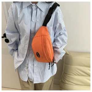 Close-up of orange nylon chest bag with FANYISSA logo and adjustable strap buckles