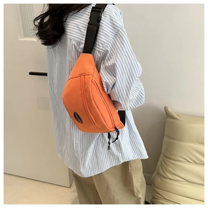 Trendy bright orange nylon fanny pack for women with adjustable strap and front logo patch