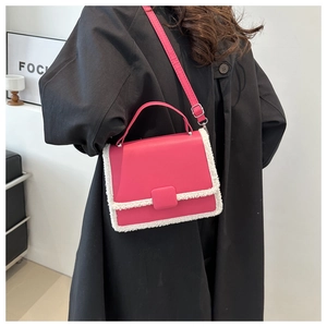 Detail of fuchsia square crossbody bag with white plush trim and leather shoulder strap