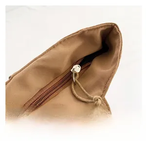 Detail of smooth metal zipper and cotton cord puller on the brown canvas tote bag