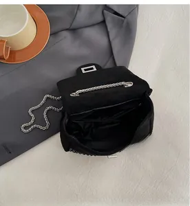 Detailed view of black rhinestone handbag interior featuring multi-layer storage compartments