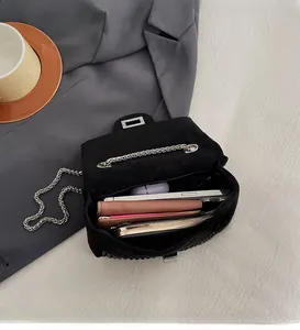 Detail view of the open black rhinestone bag showing spacious interior with daily essentials
