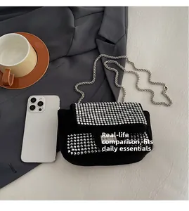 Mini rhinestone crossbody bag with silver chain strap shown next to a smartphone