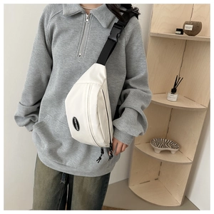 Detailed view of the white nylon chest bag with adjustable black strap and FANYISSA logo