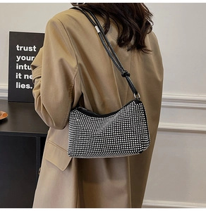 Détail du sac à bandoulière en strass argentés montrant la texture diamant et la lanière en cuir