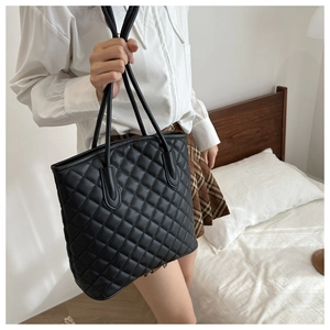 Close-up of black quilted stitching and texture on a premium PU leather tote bag