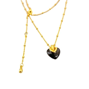 Elegant gold bead chain necklace featuring a glossy black enamel heart-shaped pendant