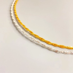 Dual-strand twisted metal neck chain in gold and silver finish with wave link design