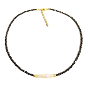 Handmade necklace featuring black faceted beads and a baroque pearl with golden clasp