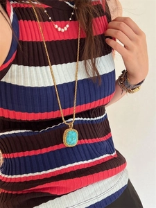Detail of vintage square pendant with large turquoise stone on a gold chunky chain necklace