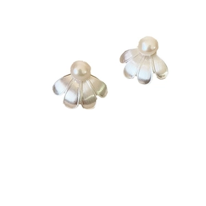 Silver brushed flower stud earrings with white freshwater pearls on a white background