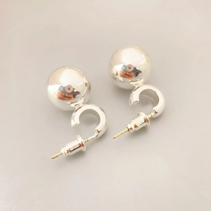 Elegant polished hollow silver ball stud earrings with minimalist spherical geometric design