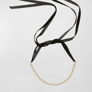 Elegant pearl necklace with black silk ribbon tie, minimalist style for women