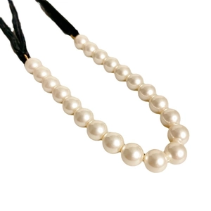 Elegant pearl necklace with black cord knot tie, featuring cream gradient pearls